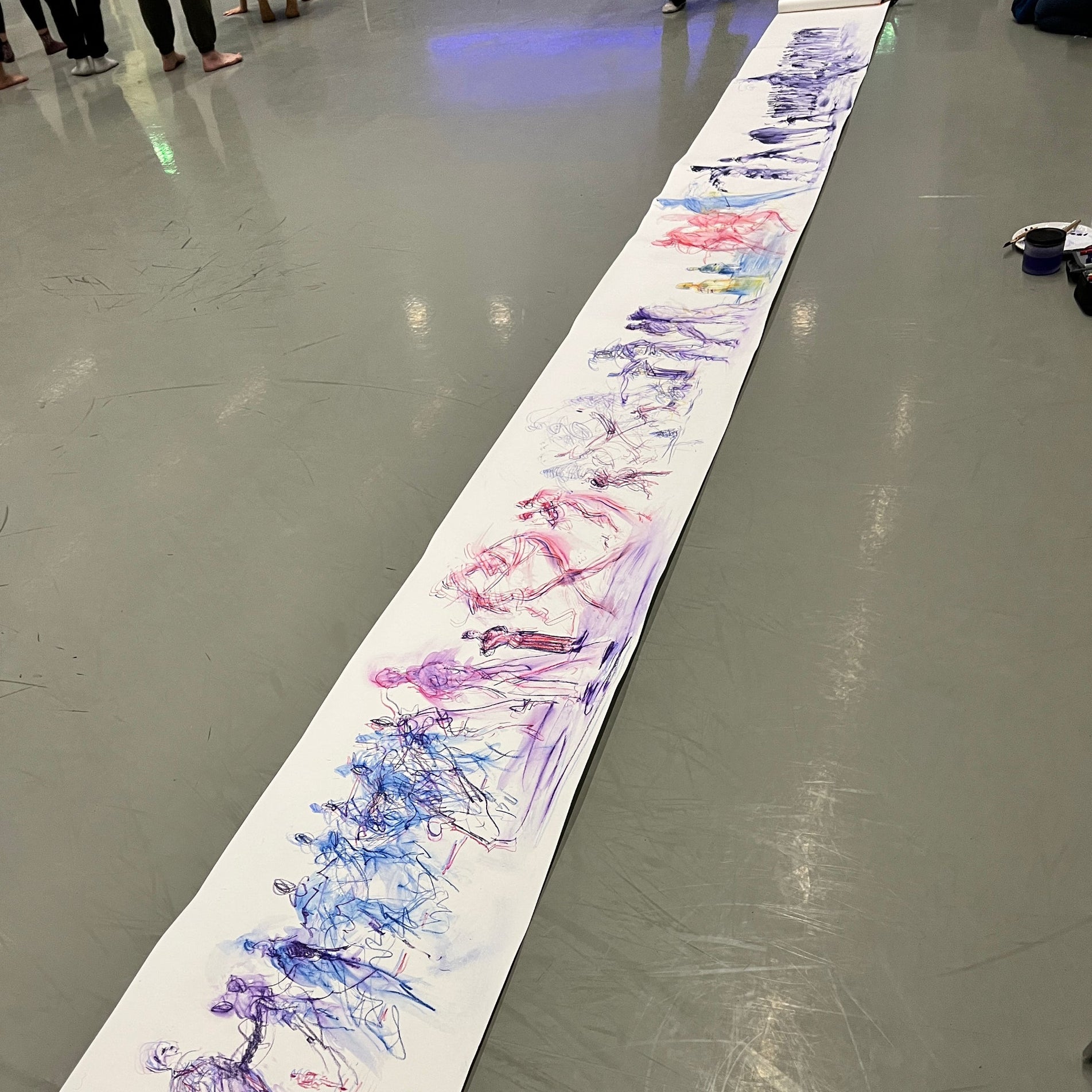 Large drawing of a dance session on a roll of paper on the dance studio floor